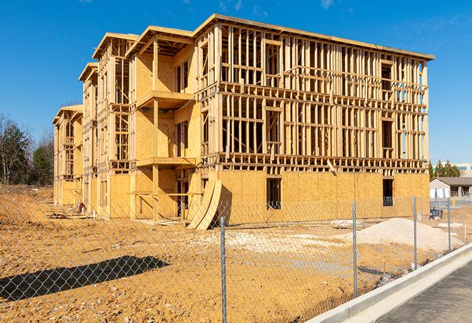 a temporary chain link fence surrounding a job site, requiring strict safety precautions in Hawaiian Gardens